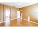 Neutral bedroom featuring hardwood floors, a closet, and an ensuite bathroom at 902 Heron Point Cir, Deland, FL 32724