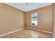 A bedroom with hardwood floors and a view from the window at 902 Heron Point Cir, Deland, FL 32724
