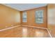 Comfortable bedroom featuring hardwood floors and two windows, perfect for relaxation at 902 Heron Point Cir, Deland, FL 32724