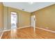 Bedroom featuring hardwood floors, neutral paint, with view of ensuite bathroom at 902 Heron Point Cir, Deland, FL 32724