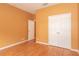 A well-lit bedroom with hardwood floors and a double-door closet at 902 Heron Point Cir, Deland, FL 32724