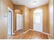 Inviting foyer with gleaming hardwood floors, arched doorway, and natural light streaming through the front door at 902 Heron Point Cir, Deland, FL 32724