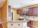 Eat in kitchen featuring granite countertops, stainless steel appliances, and wood cabinetry at 902 Heron Point Cir, Deland, FL 32724