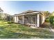 The backyard shows the screened-in lanai and the green grassy lawn at 902 Heron Point Cir, Deland, FL 32724