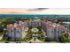 Stunning aerial view of a resort complex with a pool, lush landscaping, and the ocean in the background at 1 John Anderson Dr # 2180, Ormond Beach, FL 32176