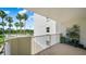 Balcony of a condo with plants and view of palm trees and the street at 1 John Anderson Dr # 2180, Ormond Beach, FL 32176