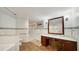 Bathroom featuring granite countertop, wood cabinets, tile flooring, shower, and decorative trim at 1 John Anderson Dr # 2180, Ormond Beach, FL 32176