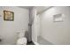 Bright bathroom with a gray herringbone-tiled shower and a toilet beside a decorative painting at 1 John Anderson Dr # 2180, Ormond Beach, FL 32176