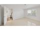 Bedroom featuring an adjacent bathroom, window, and tiled floors at 1 John Anderson Dr # 2180, Ormond Beach, FL 32176