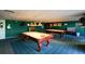 This billiard room features two pool tables and ample lighting, providing a great space for recreation at 1 John Anderson Dr # 2180, Ormond Beach, FL 32176