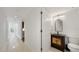 Hallway view with a bathroom including cabinet sink and toilet with a mirror at 1 John Anderson Dr # 2180, Ormond Beach, FL 32176
