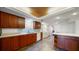 Modern kitchen has custom cabinets, backsplash, ceiling fan, and stone tile flooring at 1 John Anderson Dr # 2180, Ormond Beach, FL 32176