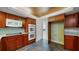 Contemporary kitchen boasts custom cabinets, stone tile flooring, and stainless steel appliances at 1 John Anderson Dr # 2180, Ormond Beach, FL 32176