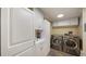 Efficient laundry room features modern washer and dryer units plus ample white cabinetry at 1 John Anderson Dr # 2180, Ormond Beach, FL 32176