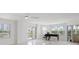 Living room featuring natural light, a piano, and a sliding glass door leading to the balcony at 1 John Anderson Dr # 2180, Ormond Beach, FL 32176