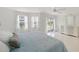 The main bedroom offers tile floors, windows, and access to a balcony with sliding glass doors at 1 John Anderson Dr # 2180, Ormond Beach, FL 32176