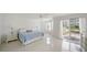 The main bedroom has tile floors and access to a balcony with sliding glass doors at 1 John Anderson Dr # 2180, Ormond Beach, FL 32176