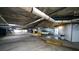 Large parking garage featuring marked spaces, overhead lighting, and visible piping for safety at 1 John Anderson Dr # 2180, Ormond Beach, FL 32176