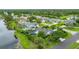 An aerial view of a neighborhood featuring mature landscaping and a lake with various homes at 101 Green Heron Ct, Daytona Beach, FL 32119