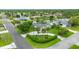 Beautiful aerial view of a home with a circular driveway, lush landscaping, and waterfront access at 101 Green Heron Ct, Daytona Beach, FL 32119