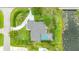 Aerial view of a home with a private driveway, screened pool, and waterfront at 101 Green Heron Ct, Daytona Beach, FL 32119