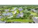 An aerial view of a house with a screened in pool, lush greenery and access to water at 101 Green Heron Ct, Daytona Beach, FL 32119