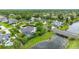 Aerial view of a house surrounded by nature and a pond at 101 Green Heron Ct, Daytona Beach, FL 32119