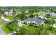 Aerial view showcasing a home with a large yard, mature trees, and serene waterways in the neighborhood at 101 Green Heron Ct, Daytona Beach, FL 32119