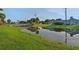 Scenic backyard with a pond, wooden bridge, lush greenery, and a glimpse of the home's rear exterior at 101 Green Heron Ct, Daytona Beach, FL 32119
