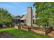 Backyard featuring a screened-in pool area, a brick fence, and lush landscaping, perfect for outdoor living at 101 Green Heron Ct, Daytona Beach, FL 32119