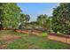 Lush backyard featuring a brick fence with decorative lanterns and tropical palm trees at 101 Green Heron Ct, Daytona Beach, FL 32119