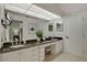 Bathroom featuring a large mirror, dual sinks, lots of counterspace and an adjacent door at 101 Green Heron Ct, Daytona Beach, FL 32119