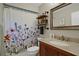 Bathroom featuring wooden vanity and floral shower curtain at 101 Green Heron Ct, Daytona Beach, FL 32119