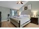 Bright bedroom featuring a tufted headboard bed, wood floors, and natural light from a window at 101 Green Heron Ct, Daytona Beach, FL 32119