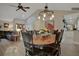Open dining room featuring wood table with black chairs, chandelier, and easy access to the living areas at 101 Green Heron Ct, Daytona Beach, FL 32119