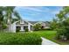 Beautiful single-Gathering home with a long driveway, and mature palm trees, and a well-manicured lawn at 101 Green Heron Ct, Daytona Beach, FL 32119
