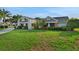 Charming home exterior with a well-kept lawn, mature landscaping, and a welcoming facade at 101 Green Heron Ct, Daytona Beach, FL 32119