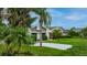 Front exterior view of a home showcasing well-maintained landscaping and a paved driveway at 101 Green Heron Ct, Daytona Beach, FL 32119