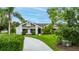 Well-maintained single-Gathering home featuring mature trees, and a lush green lawn with a long concrete driveway at 101 Green Heron Ct, Daytona Beach, FL 32119