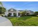 Charming single-story home with well-manicured lawn, mature landscaping, and inviting entrance at 101 Green Heron Ct, Daytona Beach, FL 32119