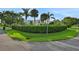 Landscaped front yard with lush greenery and palm trees surrounding a well-maintained home at 101 Green Heron Ct, Daytona Beach, FL 32119