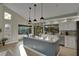 Bright kitchen featuring a large island with granite countertop and stainless steel appliances at 101 Green Heron Ct, Daytona Beach, FL 32119