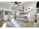 Bright living room with vaulted ceilings, ceiling fan, and hardwood floors offers ample light at 101 Green Heron Ct, Daytona Beach, FL 32119