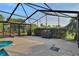 Large screened-in lanai featuring a patio and pool area perfect for grilling and enjoying outdoor living at 101 Green Heron Ct, Daytona Beach, FL 32119