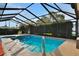 Enjoy year-round swimming in this screened in pool, adjacent to the spa, and enjoy the backyard foliage at 101 Green Heron Ct, Daytona Beach, FL 32119