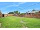Sprawling backyard features a shed, mature trees, and a brick fence at 106 Banyan Dr, Ormond Beach, FL 32176