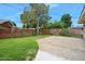 Fenced backyard featuring mature landscaping and concrete patio at 106 Banyan Dr, Ormond Beach, FL 32176