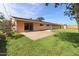 View of the back of the home with a concrete patio and fenced yard at 106 Banyan Dr, Ormond Beach, FL 32176