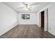 Bedroom featuring wood-look flooring, a ceiling fan, and closet storage at 106 Banyan Dr, Ormond Beach, FL 32176