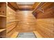 Walk in closet with floor-to-ceiling natural wood paneling and shelving at 106 Banyan Dr, Ormond Beach, FL 32176